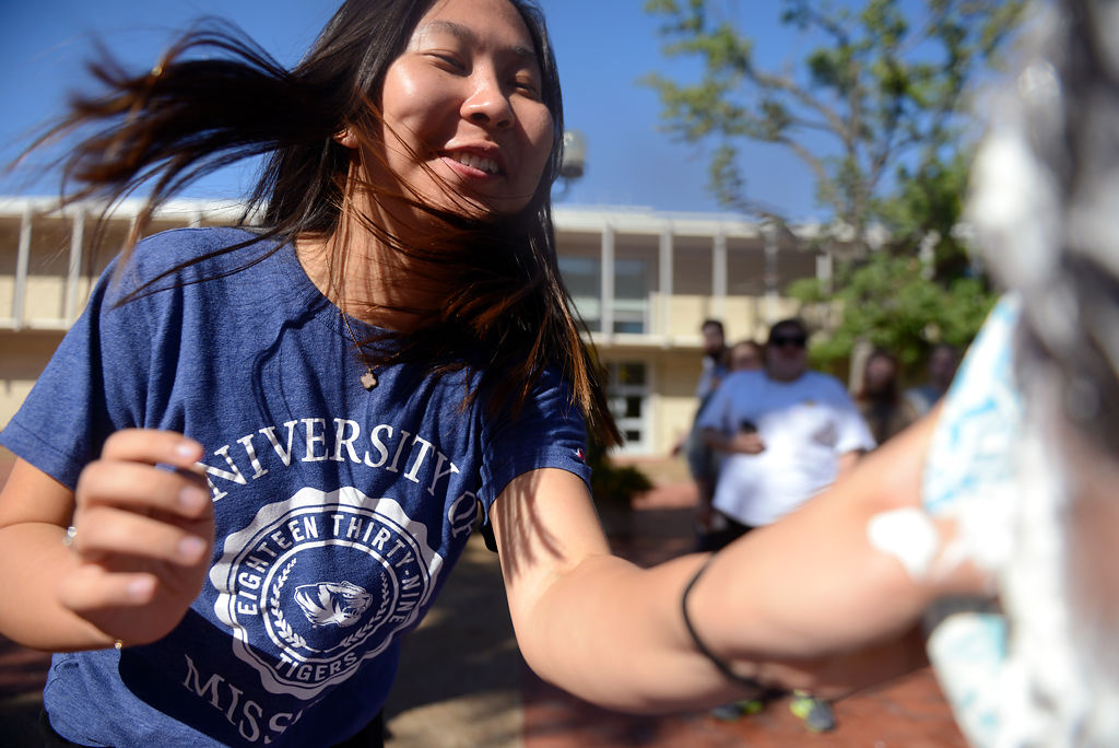 Jane Wang hits Lafe Arens with a pie